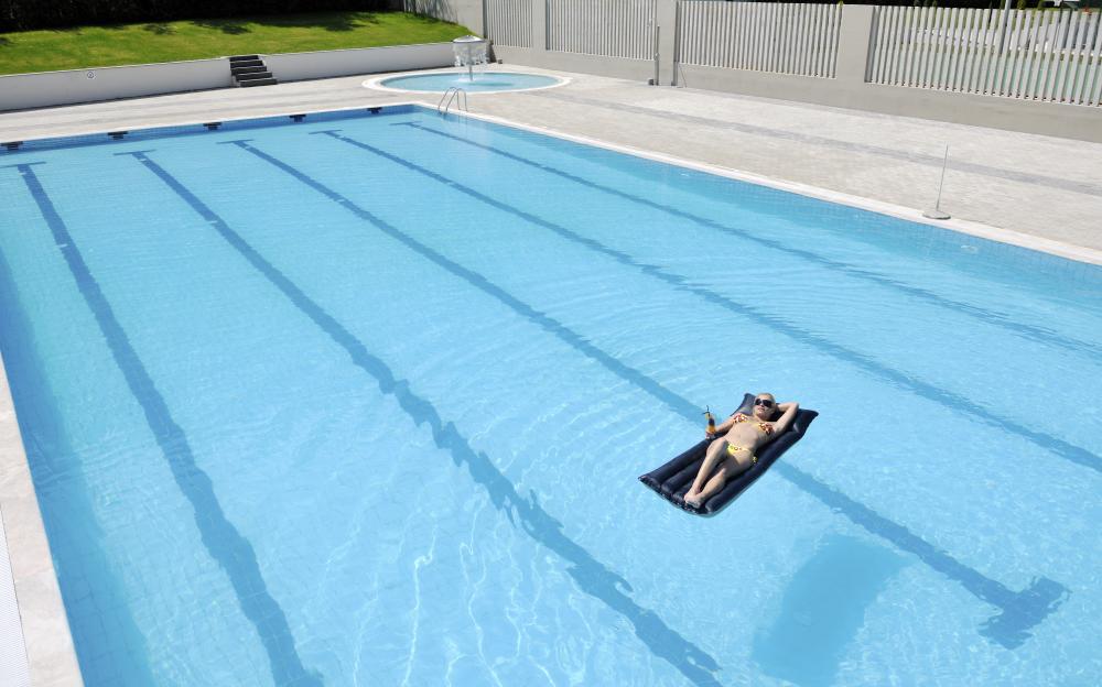 Woman enjoying warm pool thanks to Solar Pool Heaters Geneva