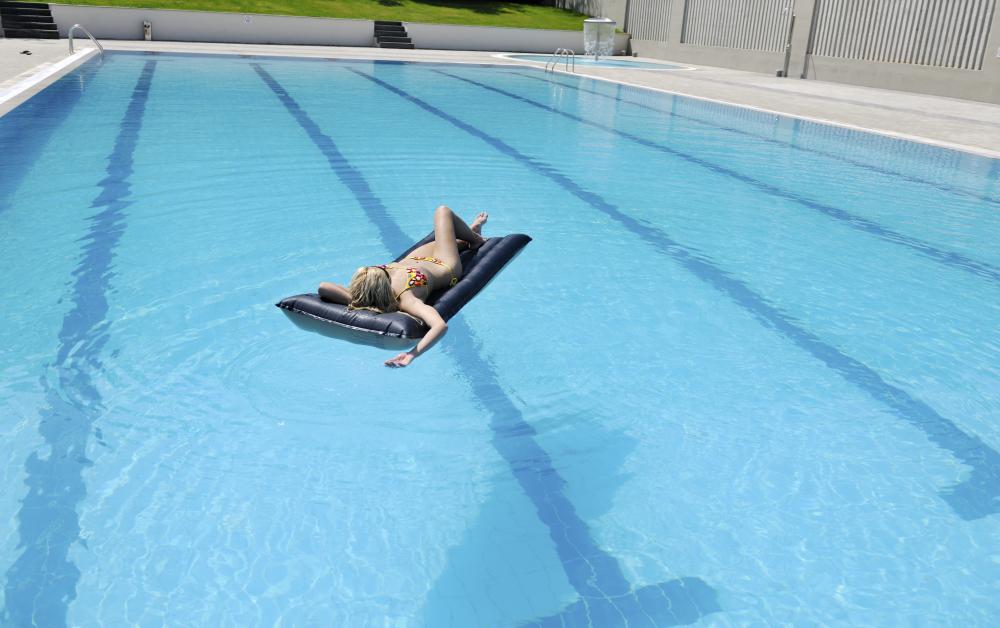 Woman enjoying warm solar heated swimming pool in Black Hammock