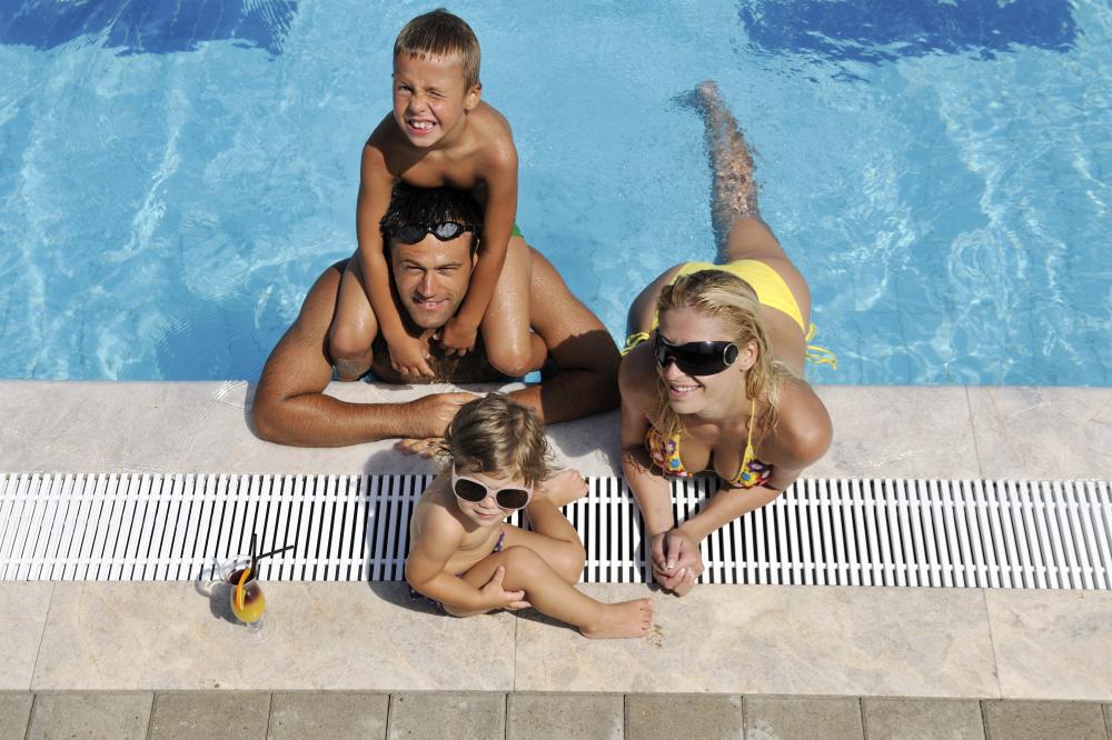 Family enjoying a warm swimming pool thanks to solar heating