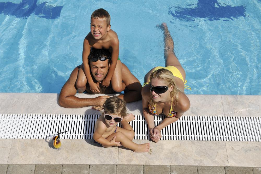Happy family enjoying their solar-heated pool in Daytona Beach