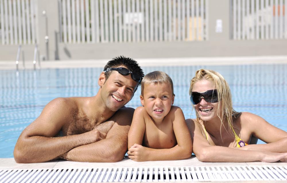 Joyful family swimming in a heated pool