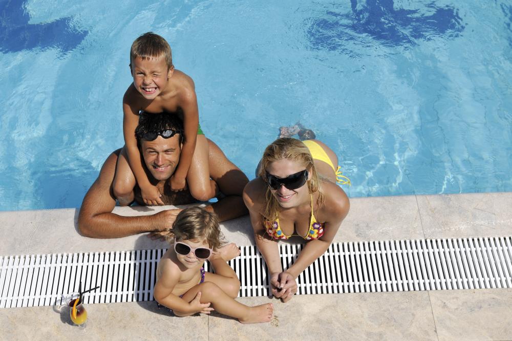Family enjoying a warm pool with solar heaters in Daytona Beach