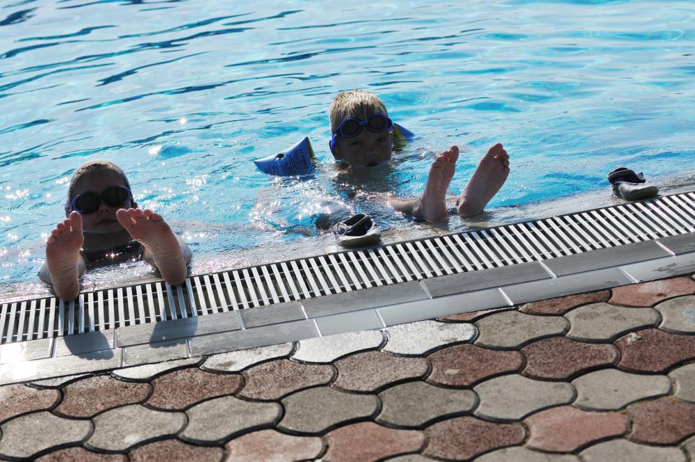 Family enjoying warm pool water with energy efficient pool heater