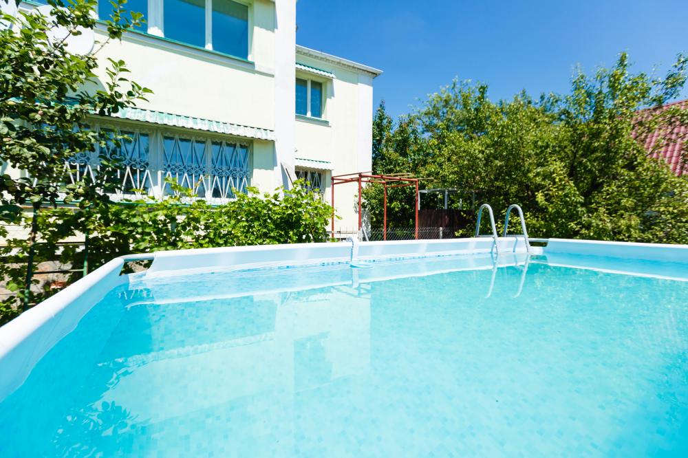 Lush backyard with a heat pump-heated swimming pool